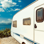 Caravan windows close up overlooking ocean