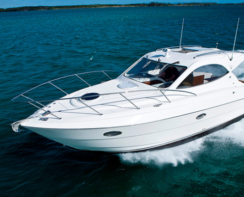 Mustang 32 | ALFAB Australia White motor yacht cutting through blue water at speed with wake behind.